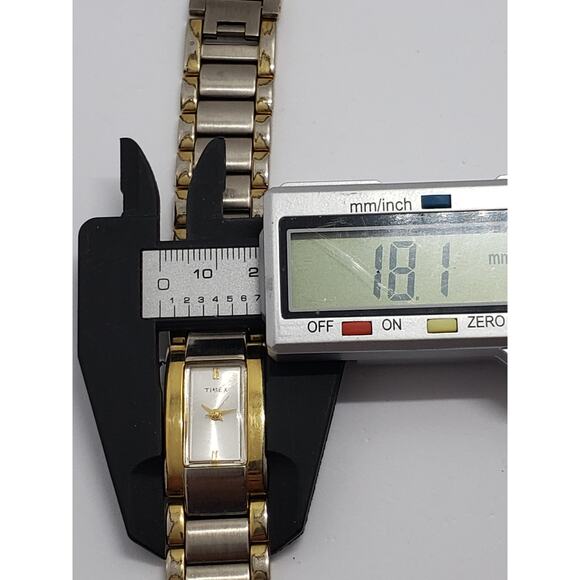 Women\'s Timex dress watch. Square white iridescent face. Large gold bevel